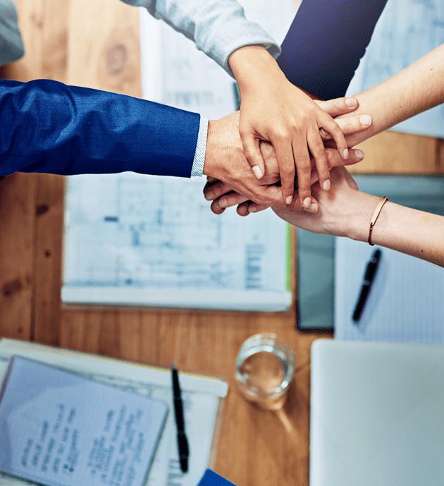 Hands stacked in team agreement gesture.