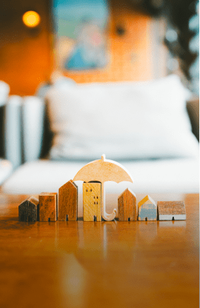 Tiny houses under a beige umbrella