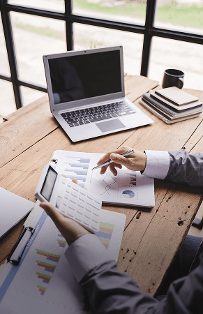 Office desk with financial data and laptop